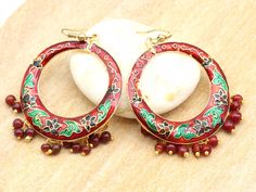 These Indian fancy earrings are typical of Rajasthan. They are hand painted in an enamel way, it is a style of manufacture called Meenakari. This earring model is red with green and black patterns. They are light to wear. These are original jewels and full of charm, for a boho style diam earring 3.5 cm -> Your order is shipped within 48 hours (working days). The packaging is very neat with pretty pockets in Indian fabrics. -> Jewelry and accessories are creations that I have made with Indian cra Earring Model, Indian Fabrics, Fancy Earrings, Indian Fabric, Jewelry And Accessories, Boho Stil, Green And Black, Black Pattern, Boho Style