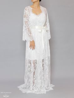 Floor length bridal lace robe with Chantilly French lace Length: 160 cm / 62 in Loose-fitting Bell sleeves Silky ribbon belt Scalloped neckline, lace cuffs and hemline Model is 160 cm/ 5'3'' and wearing a size S Lace Bridal Robe, Scalloped Neckline, Bridal Robe, Dream Dresses, Lace Cuffs, Ultra Feminine, Ribbon Belt, Lace Bridal, Bridal Robes