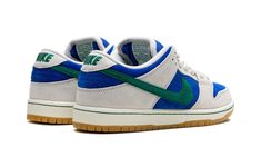 The Nike SB Dunk Low “Hyper Royal/Malachite” is a colorway of the skateboarding shoe with a can’t-miss color scheme.  Made for skateboarding or casual wear, the SB Dunk Low “Hyper Royal/Malachite” comes in eye-catching colors, with Hyper Royal suede appearing on the base and Phantom-colored suede appearing on the overlays.  A Malachite suede Swoosh logo is seen on the sides.  More Malachite accenting appears on the “Nike” embroidery on the heel and on the branding on the tongue tag.  A gum rubbe Nike Embroidery, Low Dunks, Malachite Green, Top Basketball Shoes, Affordable Shoes, Nike Sb Dunk Low, Black Converse, Nike Sb Dunks Low, Sb Dunk Low