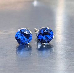 Fast First Class Shipping. Blue spinel was tested on one of the most accurate and reliable gem tester machines. And come from a reliable source. All my gemstone jewelry comes in nicely wrapped, so they are ready to be given as gifts! You will love these sparking and calming blue spinel studs. They shine and glisten almost like a diamond in the sunlight. Blue Spinel helps with mental focus and nervous energy, It will help complete a task until the end. Helps maintain progress. Helps purify negati Blue Round Cut Jewelry With Prong Setting, Blue Prong Set Round Cut Jewelry, Blue Birthstone Jewelry For Anniversary, Nickel-free Sapphire Round Earrings, Blue Diamond Cut Jewelry For Gift, Blue Diamond Cut Jewelry Gift, Blue Round Birthstone Jewelry, Royal Blue Jewelry With Prong Setting For Anniversary, Blue Jewelry With Prong Setting As Gift