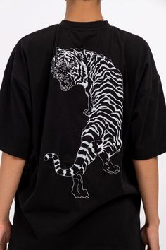 IMperfectionists Classic Tiger design on a 100% cotton textile with the perfect oversize cut. The Tiger and Copenhagen front logo are embroidered to ensure higher quality and durability. The T-shirt size is true to general EU unisex sizes. Material: 100% Deadstock Cotton Color: Black Care instruction - Wash in cold (30°C or below) water - Don't tumbledry - Iron on low heat - Don't wash together with dark or colourful clothes. Longer the use better for our environment, so please apply the followi Black Embroidered T-shirt For Streetwear, Oversized Black T-shirt With Front And Back Print, Black T-shirt With Embroidered Graphics And Relaxed Fit, Oversized Embroidered Tops For Streetwear, Oversized Black T-shirt With Embroidered Graphics, Oversized Cotton T-shirt With Front And Back Print, Oversized Black Top With Embroidered Graphics, Black T-shirt With Embroidered Graphics For Streetwear, Black Embroidered Graphics T-shirt For Streetwear