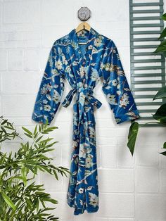 Indulge in the luscious luxury of our printed velvet robe, featuring a soft Silk lining. With its reversible design, you can choose between the stunning outer print or the comforting feel of the lining against your skin. Perfect for autumn and winter, this dressy robe is also a great choice for unpredictable cold weather. ONE SIZE Length: 50" Inch approx Chest: 50" Inch approx Sleeve: 21" Inch approx Our robe features two convenient pockets and a generous length of belt for easy home lounging.  It's also perfect for bridal makeup sessions and new moms during winter maternity.  Please note that this robe is not lightweight.  We strive to accurately capture the colors in our photography, but please be aware that screen resolution may slightly affect the appearance. We take our photos in natu Blue Floral Print Robe For Home, Blue Valentine, Printed Velvet, Winter Maternity, Braut Make-up, Winter Gift, Womens Robes, Kimono Jacket, Elegant Floral