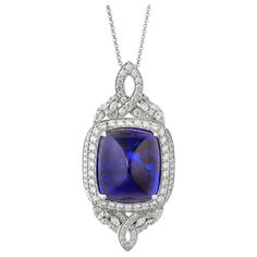 This collection features a selection of the most tantalizing Tanzanites. This enchanting East African gemstone can only be procured from one mine in the foothills of Mount Kilimanjaro, Tanzania. We have accented the rich purple-blue hues of this gemstone with diamonds set in white gold to present a rich and regal look. Classic tanzanite pendant in 18K white gold with diamonds. Tanzanite: 67.25 carat cushion sugarloaf shape, 23.14X19.45mm size. Diamonds: 4.042 carat, G colour, VS clarity. Gold: 1 Luxury Cutdana Pendant Jewelry, Luxury Tanzanite Pendant Jewelry, Luxury Tanzanite Pendant Necklace, Luxury Tanzanite Necklaces With Prong Setting, Luxury Tanzanite Necklace With Brilliant Cut, Exquisite Gemstone Diamond Necklace For Formal Occasions, Exquisite Gemstone Diamond Necklace For Formal Events, Exquisite Formal Gemstone Pendant, Exquisite Pendant Gemstones For Formal Occasions