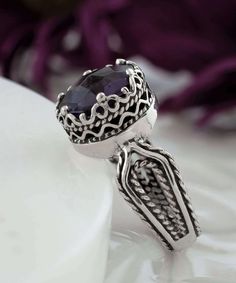 Looking for the perfect gift for your girlfriend, wife, mother, or sister? This gorgeous silver filigree art women's cocktail ring is the ideal choice. With its intricate details and beautiful face-up design, this ring is sure to stand out and make an impression. It features a double-sided, faceted checkerboard round-cut amethyst gemstone that measures 10mm and has a face size of 0.47 inches (12.00mm) in width. Not only is this ring stunning, but it also comes with a velvet pouch, silver polish Elegant Silver Crystal Ring With Birthstone, Elegant Silver Crystal Birthstone Ring, Elegant Adjustable Crystal Ring With Stone Setting, Formal Birthstone Ring With Round Stone, Spiritual Oval Ring With Intricate Design, Purple Promise Ring With Intricate Design, Spiritual Oval Rings With Intricate Design, Spiritual Promise Ring With Intricate Design, Purple Intricate Design Promise Ring