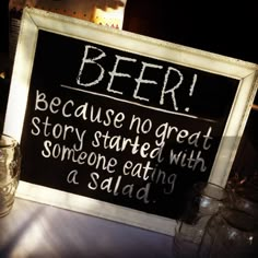 a sign that says beer because no great story started with someone eating a salad on the table