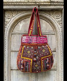 About bag  Indo-gypsy fusion, everyday use hand bag made from Banjara fabrics sourced from Vintage tribal costumes of regions of Rajastan and Gujarat. These are embellished with light catching coins, and intricate bead work tassels. Size - length 15 inches/ width 21 inches Company details:  Company name: Houseoftextile  Contact number: +919784447473  Email id: houseoftextile77@gmail.com  Shipping & custom : Delivery through one of the finest service providers : Skyway, Fedex, UPS  And DHL. Any l Bohemian Multicolor Bags With Zari Work, Bohemian Multicolor Potli Bag For Festive Occasions, Bohemian Multicolor Potli Bag For Festive Season, Traditional Bags With Mirror Work For Festivals, Bohemian Multicolor Zari Work Bag, Multicolor Bohemian Potli Bag For Festive Occasions, Festive Bag With Mirror Work For Festivals, Bollywood Bags With Mirror Work For Festivals, Navratri Bohemian Potli Bag With Handwork