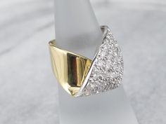 The simple wrap design of this ring is what saves it from being over the top, and keeps it the classy, sophisticated piece that it is. Rows of fine, bright, sparkling diamonds sit flush to the mounting, a perfect anniversary or cocktail piece!Metal: 18K Yellow and White GoldGem: 40 Diamonds totaling 2.15 Carats, SI1 in Clarity, H in ColorGem Measurements: 3.3 mm, RoundRing Size: 4.50Marks: "18K" Stamped on the inside band Formal Fine Jewelry Diamond Ring With Tension Setting, Formal Tension Setting Diamond Ring, Modern Wide Band Diamond Ring For Wedding, Formal Diamond White Bypass Ring With Tension Setting, Elegant Wide Band Ring With Tension Setting, Elegant Pave Setting Bypass Ring For Anniversary, Elegant Wide Band Wedding Ring With Single Cut Diamonds, Modern Pave Setting Diamond Ring For Formal Occasions, Modern Bypass Ring With Round Cut For Formal Occasions