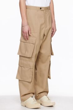 Polyester- and cotton-blend gabardine cargo pants. · Paneled construction · Belt loops · Four-pocket styling · Zip-fly · Bellows pockets at outseams · Horn hardware Supplier color: Beige Beige Wide Leg Cargo Pants With Cargo Pockets, Beige Cotton Cargo Pants With Multiple Pockets, Baggy Khaki Work Pants With Multiple Pockets, Baggy Work Pants With Cargo Pockets, Beige Utility Parachute Pants With Belt Loops, Beige Utility Pants With Patch Pockets, Baggy Khaki Cargo Pants With Belt Loops, Beige Cargo Jeans With Pockets For Work, Utility Khaki Pants With Flap Pockets