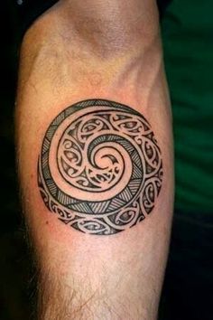 a man's arm with a tattoo on it that looks like a spiral design