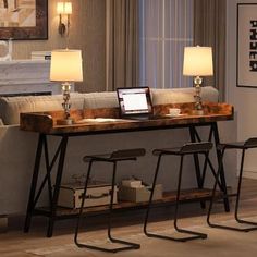 a living room filled with furniture and a laptop computer on top of a wooden table