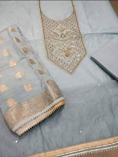 Item Overview ATHARVA Hand Embroidered Salwar Kameez w/Beautiful Embroidered Neck Grey/Banarsi Silk Dupatta/Latkan Tassel/Wedding/Bridal Trousseau Dno. CH1415 Fabric: * Shirt Chanderi Silk in Grey - 2.5 Mts, with Embroidered Neck * Dupatta: Banarsi Silk Dupatta - 2.5 Mts - (Motifs may wary) * Bottom Santoon Silk 2.5 Mts. Excusive Hand Embroidered Party Wear Punjabi Suit. Customization: * Fabrics Customization: Designs Can be made in different Fabrics. * Color Customization: Designs Can be made i Ceremonial Gota Work Kurta, Unstitched Gota Work Kurta For Ceremonial Occasions, Ceremonial Chanderi Salwar Kameez With Gota Work, Chanderi Churidar With Gota Work For Transitional Season, Designer Chanderi Churidar For Transitional Seasons, Semi-stitched Raw Silk Set With Gota Work, Traditional Ceremonial Salwar Kameez With Gota Work, Traditional Gota Work Salwar Kameez For Ceremonies, Bollywood Style Ceremonial Kurta With Gota Work