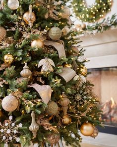 a christmas tree decorated with gold and silver ornaments