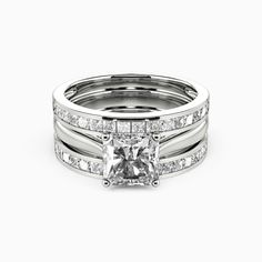 a princess cut diamond ring set with channeled bands