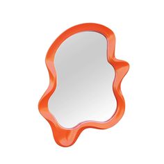 an orange scallop shaped mirror on a white background