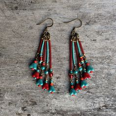 Beautiful and original red and pale blue tones, bronze bohemian Czech glass leaf earrings.  Spiritual Jewelry designed and carefully handmade by Rushweaver Jewellery in an ancient earthy tribal style.  These boho beauties dangle 78mm from the top of nickel free brass ear wires. For all free spirited women who want to enjoy their unique style! Bohemian Brass Beaded Earrings With Ear Wire, Bohemian Adjustable Beaded Brass Earrings, Bohemian Brass Beaded Drop Earrings, Turquoise Handmade Tassel Earrings For Festivals, Bohemian Handmade Dangle Earrings, Bohemian Turquoise Beaded Earrings With Brass, Bohemian Turquoise Beaded Earrings In Brass, Bohemian Drop Earrings, Bohemian Turquoise Beaded Brass Earrings