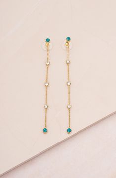 Green opals detail the top and bottom of elegant linear drop earrings plated in high-shine 18-karat gold. 3 1/2" drop Post back 18k-gold plate/cubic zirconia/green opal Imported Green Linear Drop Earrings For Formal Occasions, Dainty Green Dangle Earrings, Green Fine Jewelry Drop Earrings, Elegant Green Drop Linear Earrings, Dangle Earrings Opal, Green Gems, Green Opal, Opal Earrings, Gold Plated Earrings