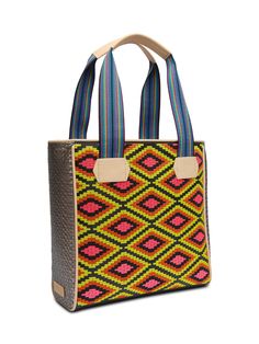 The Classic Tote has been our signature Consuela silhouette since the beginning. This bold and colorful embroidered tote bag holds its shape while carrying all of the essentials. You’re ready for anything that comes your way! Details & Sizing Rae embroidered pattern and Diamond exterior Lex woven side panels Interior slide pocket and zipper pocket Comfortable woven straps Trimmed in natural, untreated leather 13 ½” (W) x 13 ½” (H) x 5 ½” (D), 9 ¾" handle drop Made in Mexico Pattern placement may Casual Multicolor Embroidery Travel Bags, Casual Multicolor Embroidered Travel Bags, Casual Travel Bags With Multicolor Embroidery, Multicolor Embroidered Bag With Removable Pouch, Multicolor Embroidered Tote Bag For Daily Use, Everyday Bags With Multicolor Embroidery And Removable Pouch, Everyday Multicolor Embroidered Rectangular Shoulder Bag, Everyday Multicolor Embroidered Rectangular Satchel, Everyday Rectangular Shoulder Bag With Multicolor Embroidery