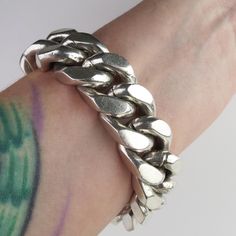 Super thick sturdy heavy sterling links flow around this vintage Mexican bracelet. The bracelet is constructed with 15/16 inch x 3/4 inch links that have a 9.2mm (3/8 inch) thickness. The heavy links have flat edges and conform to the wrist nicely. The bracelet closes with a long and wide curved box clasp topped by a push-bar button. The hefty bracelet contains over 200 grams of sterling silver. The 3/4 inch wide bracelet has an inner circumference of approx. 6 1/2 inches. The back is stamped, "Mexico, IA-20" and hallmarked, "925" (sterling silver). The links and hardware also tested as sterling silver purity.  This piece is in wonderful condition for its heavy weight, with expected minor surface wear and patina. Please see photos for condition and below for detailed measurements. Wt: 213. Modern Silver Cuban Link Bracelet With Chunky Chain, Classic Silver Chunky Jewelry, Silver Chunky Classic Jewelry, Classic Chunky Silver Jewelry, Classic Silver Cuban Link Bracelet With Chunky Chain, Chunky Oval Link Silver Chain Bracelet, Silver Chunky Oval Link Chain Bracelet, Modern Silver Chunky Chain Bracelet, Elegant Silver Cuban Link Bracelet With Chunky Chain