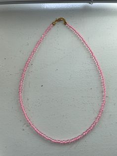 a pink and clear beaded necklace, perfect for summer!! Pink Crystal Necklaces With Faceted Round Beads, Pink Beaded Necklaces With Heart-shaped Beads, Pink Beaded Necklaces With Heart Beads, Pink Round Beads Crystal Necklaces For Jewelry Making, Pink Heart Beads For Summer, Pink Crystal Necklace With Beaded Chain, Summer Pink Necklaces With Tiny Beads, Pink Tiny Beads Necklace For Summer, Adjustable Pink Crystal Necklace With Beaded Chain