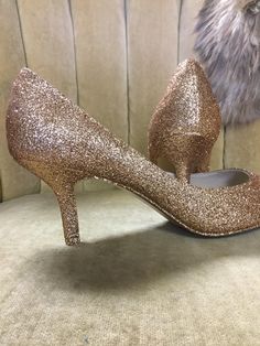 "These beautiful glitter high heels are covered in a rose gold glitter and sealed with a two step sealant that allows for movement and will not dull the shin of the glitter. This rose gold color is best described as a gold with a rose undertone. It is not an externally pink rose gold but does have a beautiful hint of pink undertones. Please note that the example heels in the photo are a size 8 shoe with a 3\" heel. Sizes 5-12 are available at checkout along with three different heel heights. All Gold Court Shoes With 4-inch Heel For Evening, Gold Wedding Shoes With 4-inch Heel, Gold Court Shoes With 4-inch Heel And Almond Toe, Gold Sparkling Low Heel Shoes, Gold Sparkling Low Heels, Gold High Heel Court Shoes With 4-inch Heel, Gold Pointed Toe Court Shoes With Deep Heel Cup, Gold Closed Toe Heels For Prom, Elegant Gold Shimmer Heels