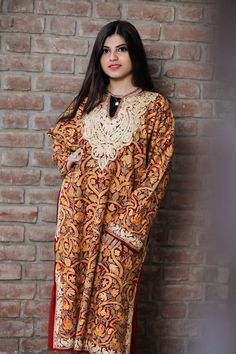 A stunningly marvellous Pheran. This Pheran features intricate Kashmir Aari embroidery on all-over the front side and on the sleeves.- - - - - - - - - - - - - - - - - - - - Product Details- Condition: Brand New (made to order)- Style: Phiran Tunic- Fabric: Pure Wool- Colour: Red- Embroidery: Jaal Aari Work- Embroidery Colour: Multi-Colour- Standard Length: 40" | Can be customized- Care Instructions: Dry Clean Only.**If you want the Tunic to be shorter or longer, just send us a message, and we wi Bollywood Style Dabka Kaftan For Traditional Ceremonies, Festive Kaftan With Pallu For Transitional Season, Transitional Festive Kaftan With Pallu, Elegant Festive Multicolor Embroidered Kaftan, Festive Elegant Multicolor Embroidered Kaftan, Embroidered Dabka Fabric For Traditional Ceremonies, Traditional Shantoon Wear With Dabka For Ceremonies, Shantoon Traditional Wear With Dabka For Ceremonies, Shantoon Traditional Wear With Intricate Embroidery For Festivals