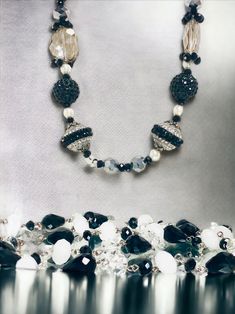 Indulge in the allure of bygone eras with our Vintage-Looking Black and White Costume Jewelry Necklaces. This necklace brings a touch of nostalgia and classic charm to your modern style, making it a must-have for lovers of vintage aesthetics.  With its vintage-inspired design and classic color palette, this necklace is the perfect accessory to transform any outfit into a masterpiece of timeless beauty. Whether you're attending a themed event or simply adding a touch of vintage charm to your dail Vintage Crystal Jewelry With Faceted Beads, Polished Beads Necklace For Evening, Evening Necklace With Polished Beads, Vintage Formal Beaded Necklaces With Faceted Beads, Classic Beaded Jewelry For Party, Vintage Crystal Necklace With Single Strand Round Beads, Vintage Single Strand Crystal Necklace With Round Beads, Elegant Large Beads Bracelets For Party, Elegant Large Beads Bracelet For Party