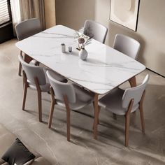 a white marble dining table surrounded by grey chairs