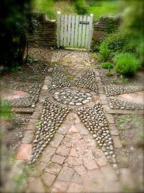 a path made out of rocks and stones in the middle of a garden