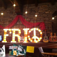 there is a sign that says frio on the wall and lights are hanging above it