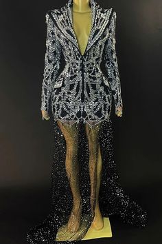 a mannequin dressed in black and white sequins with an elaborate jacket