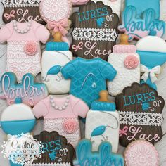 decorated cookies are arranged in the shape of baby's clothes and booties with names on them