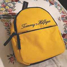 Tommy Hilfiger Yolk Yellow Mini Backpack Brand New With Tags Yolk Yellow Canvass With Navy Blue Accents Traditional Tommy Branding Size 9w X 11h X 4d Tommy Hilfiger Backpack, Tommy Hilfiger 90s, Gym Sack, Gym Backpack, Daypack Backpack, Tommy Hilfiger Bags, Grey Backpacks, Tommy Hilfiger Vintage, Tommy Hilfiger Logo