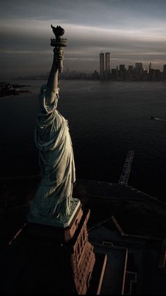 the statue of liberty in new york city, ny at night with its lights on