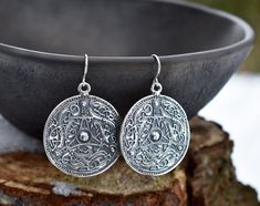 "Handmade sterling silver or 14-K gold-plated sterling silver earrings in form of a Viking shield. Inspired by a find in Sweden, in the 11th century. The same design pendant and earrings in bronze are also available. You can find the here: https://www.etsy.com/listing/1189914979/ If you would like to order these earrings in rose gold plating or made from pure 14-K yellow or rose gold, please, contact us to make a custom order! PRODUCT DETAILS Earrings: -Diameter: 35 mm/ 1.38\" -Drop length: 45 m Silver Symbolic Pendant Earrings, Symbolic Silver Pendant Earrings, Round Engraved Sterling Silver Earrings, Engraved Sterling Silver Round Earrings, Engraved Sterling Silver Earrings, Silver Engraved Round Earrings, Traditional Silver Round Pendant Earrings, Silver Sterling Silver Medallion Earrings, Silver Symbolic Engraved Earrings