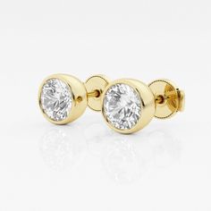 two pairs of yellow gold earrings with round cubics on each side, set against a white background