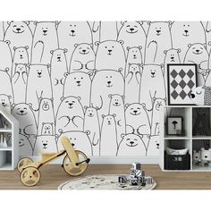 a wall with bears on it next to a book shelf and toy car in front of the wall