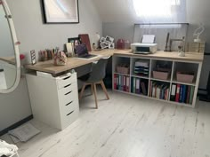 a room with a desk, bookshelf and mirror