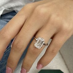 a woman's hand with a diamond ring on it