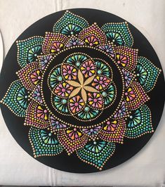 a black plate with colorful designs on it