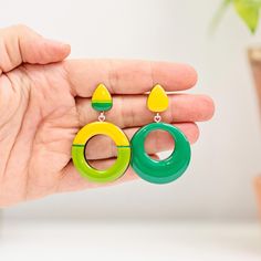 Add style and elegance to your outfitsw with these Green Mismatched Geometric Earrings!  The autumn-inspired colors make them a perfect accessory for the season. They make a thoughtful gift for Mom or Sister on their birthday, or treat yourself to a pair and turn heads wherever you go! Handmade with wooden elements and finished with epoxy resin the earrings come in three type of suspension: clip-on, silver, or silicone studs. More geometric earrings: https://www.etsy.com/shop/JewelryKatMade?sect Trendy Yellow Hoop Earrings For Gift, Trendy Yellow Hoop Earrings As Gift, Retro Hypoallergenic Earrings For Gift, Modern Green Hoop Earrings As Gift, Bold Yellow Drop Earrings, Modern Yellow Single Earring, Yellow Drop Hoop Earrings As Gift, Modern Yellow Dangle Earrings, Retro Clip-on Jewelry For Gifts