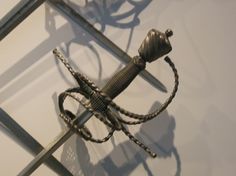 a large metal object is on display in a glass case with a chain attached to it