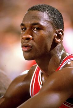 a close up of a basketball player with his hands on his chest and looking off to the side