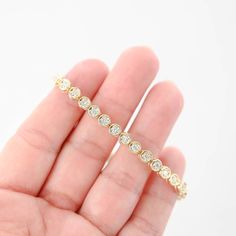 Featuring a total carat weight of 1.44. Crafted to perfection, this bracelet sparkles with every movement, making it a luxurious addition to any jewelry collection or a stunning gift for someone special. Bracelet length: 7"Bracelet width: 5 mmClosure style: Tennis claspMaterial: 14K Yellow GoldWeight: 13.9gDiamonds: 36 x 0.04Ctw = 1.44CtwColor And Clarity: G-H/SI1Total Carat Weight: 1.44Ctw For more of our jewelry products, please visit our shop 777jewelry Free shipping on all orders within the USA. International shipping available. We only sell real gold jewelry. We do not sell gold plated or gold filled jewelry. We offer a 30 day money back guaranteed return on all orders. Our goal is to make every customer satisfied. Fine Jewelry Diamond Bracelets With Channel Set, Luxury Cubic Zirconia Channel Set Bracelets, Fine Jewelry Tennis Bracelet With Bezel Setting, Channel Set Round Cut Diamond Bracelet, Gift Tennis Bracelet With Bezel Setting And Round Cut, Luxury Tennis Bracelet With Bezel Setting, Gift Tennis Bracelet With Bezel Setting, Luxury Cubic Zirconia Bracelet With Bezel Setting, Luxury Tennis Bracelet With Bezel Setting For Anniversary