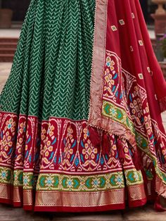 Introducing our stunning "attractive green patola printed silk function wear lehenga choli" that is sure to make you stand out at any festival or special occasion. This gorgeous ensemble features a green color tussar silk material lehenga with intricate foil work and patola print detailing, paired with a red color tussar silk choli also embellished with patola print work and foil work. Completing the look is a red color tussar silk dupatta with patola print work and tassels attached on both side Green Banarasi Silk Choli With Traditional Patterns, Traditional Green Choli With Dupatta, Green Choli With Traditional Drape For Festive Occasions, Unstitched Green Lehenga With Zari Work, Green Unstitched Traditional Lehenga, Green Anarkali Salwar Kameez In Art Silk, Traditional Green Art Silk Lehenga, Green Traditional Sharara With Meenakari, Traditional Green Sharara With Meenakari