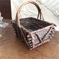 a basket made out of wooden sticks sitting on top of a table