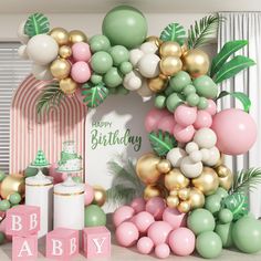 a birthday party with balloons, cake and decorations in pastel pink, green and gold colors