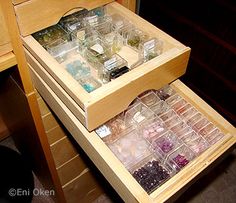 the drawers are filled with different types of beads