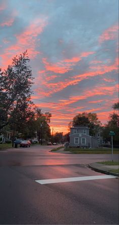 the sky is pink and blue as the sun sets