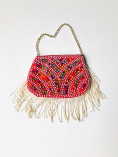 "This is a fun vintage pouch embellished with bright and colorful plastic beadwork. Measurements: Length - 6\" Height - 4\" + 2.5\" strands Chain - 9\" All of my items come from a smoke-free and pet-free home. If you have any questions, please don't hesitate to ask!" Bohemian Beaded Clutch For Festivals, Bohemian Multicolor Embellished Clutch, Bohemian Beaded Festival Clutch, Traditional Multicolor Beaded Clutch, Embellished Multicolor Festival Shoulder Bag, Embellished Multicolor Shoulder Bag For Festivals, Bohemian Beaded Pouch Clutch, Red Bohemian Handmade Clutch, Festive Multicolor Beaded Bag