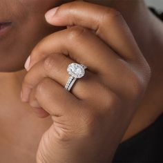 a close up of a person wearing a diamond ring